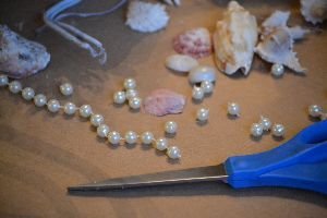 cutting up a long strand of pearl beads_small